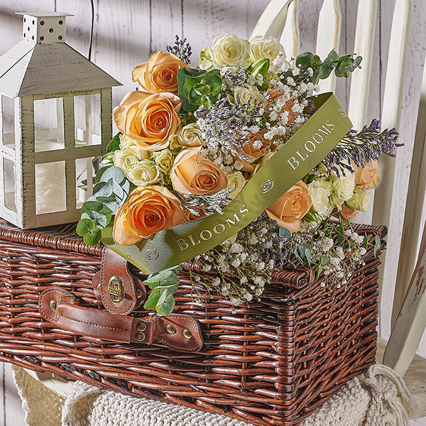 Floral arrangement in a wicker basket with Toronto Blooms ribbon