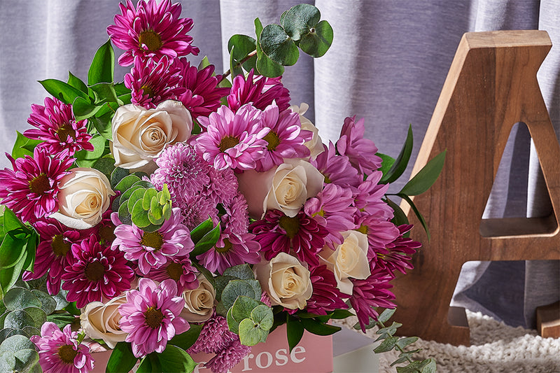 Bouquet of pink and white flowers by Toronto Blooms with a wooden letter 'A' in the background.