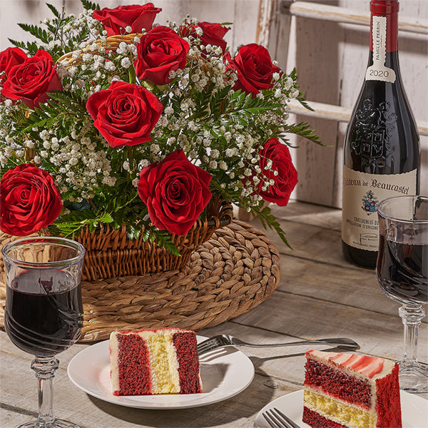 Anniversary setting with red roses, cake and wine