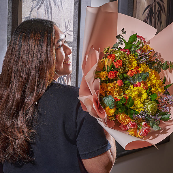 Woman holding a bouquet of flowers from Toronto Blooms