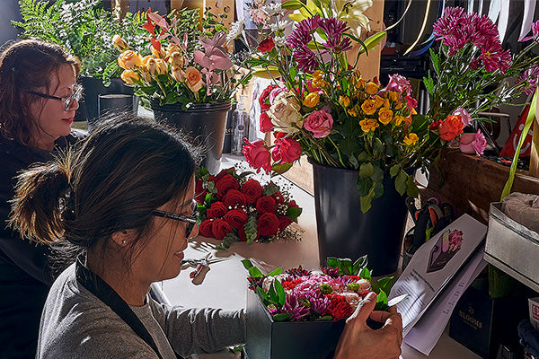 Florist designing a fresh flower arrangement in Toronto