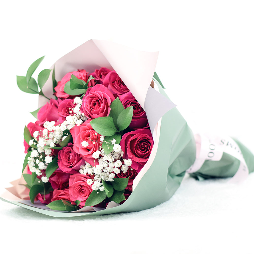 bouquet with pink roses, ruscus and baby's breath wrapped in floral wrap and designer ribbon, Same Day Toronto Delivery
