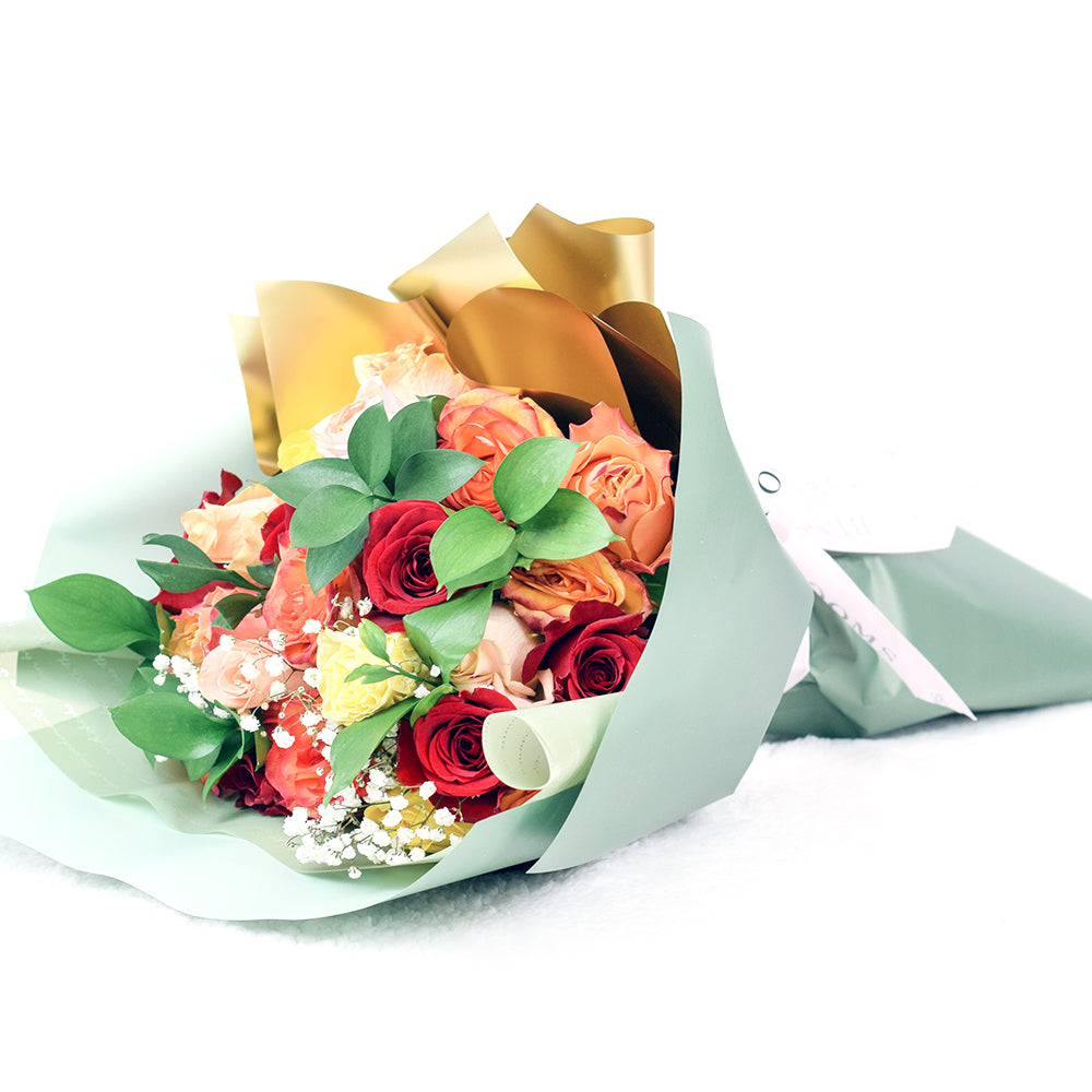 Bouquet with red, orange and yellow roses. Baby's breath and ruscus